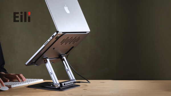 a macbook on a laptop stand with hub on the table