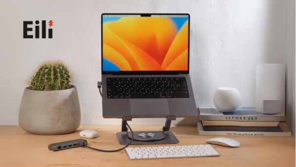 a macbook on a laptop stands with hubs on the table