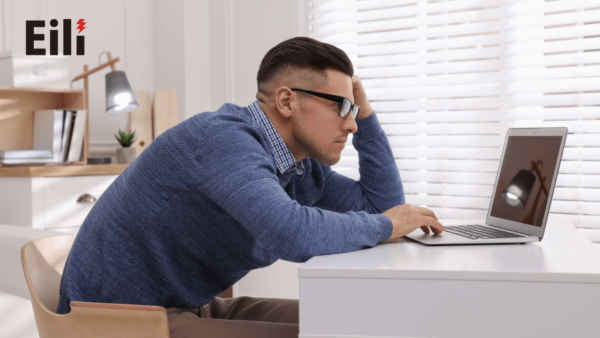 a man using laptop without laptop stands