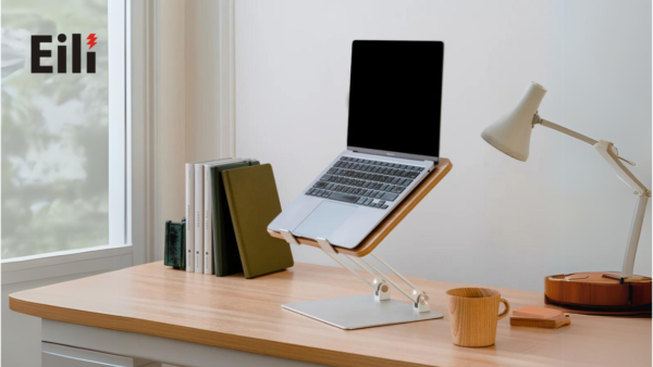 a working desk with a laptop stands